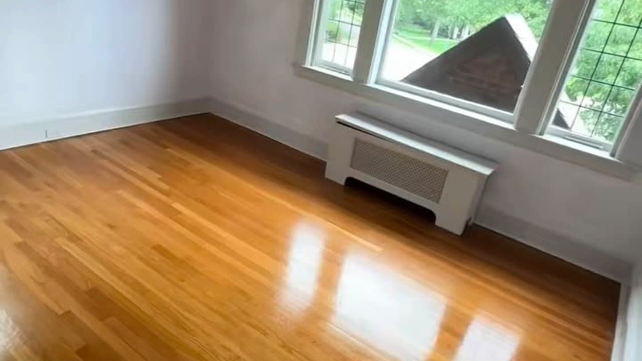 Freshly cleaned hardwood floors in an empty living room